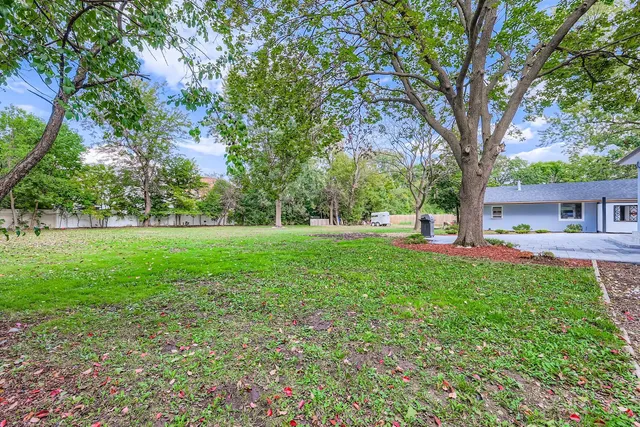 a view of a house with yard and tree s