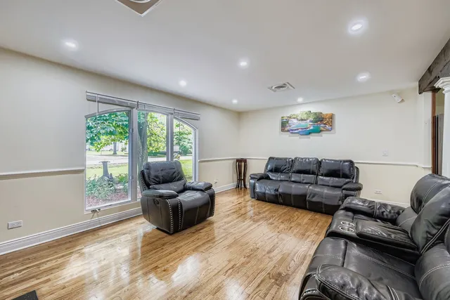 a living room with furniture and large windows