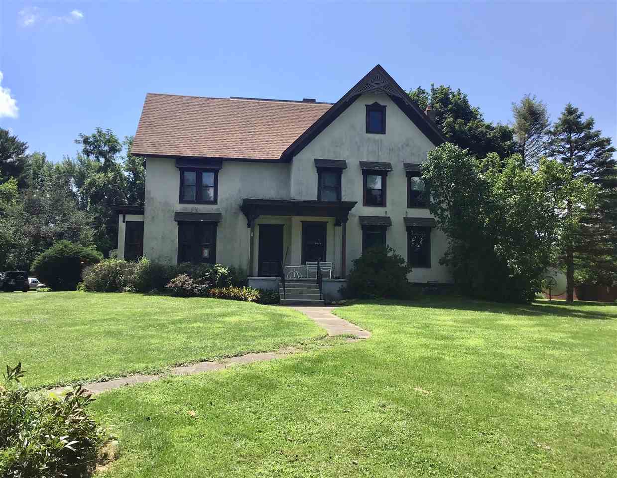504 West Cunningham Road Winnebago, IL 61088 - Photo 1 of 25 a front view of a house with a yard and trees