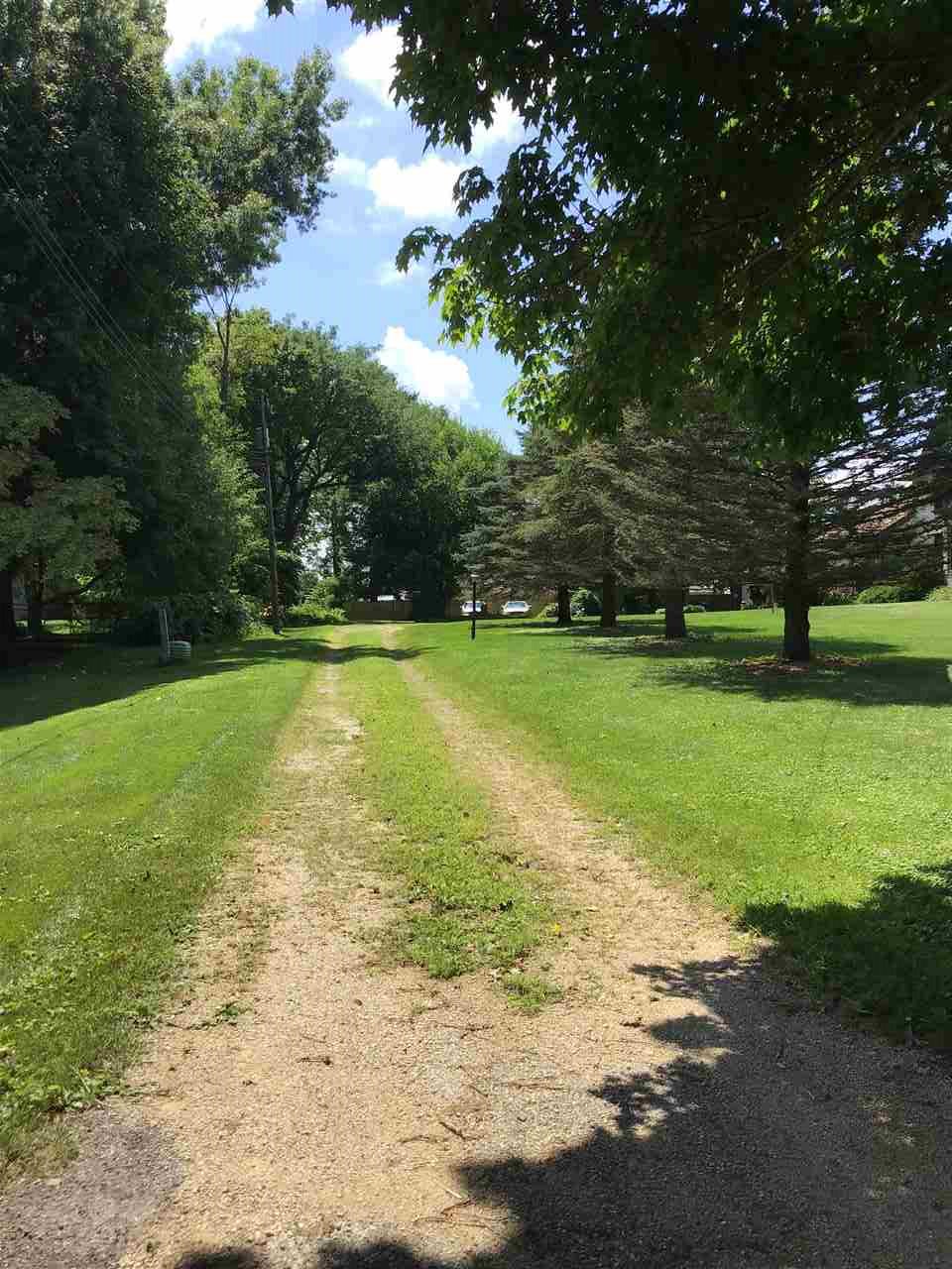 504 West Cunningham Road Winnebago, IL 61088 - Photo 25 of 25 a view of a swimming pool with lawn chairs and large trees