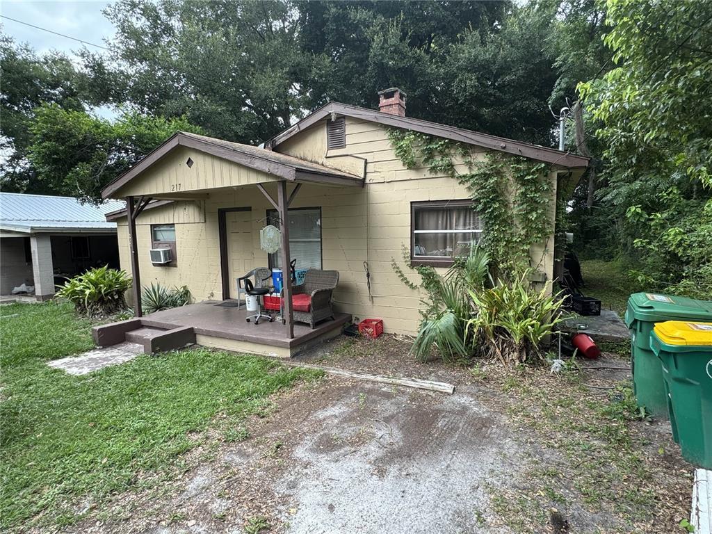 a view of a house with a yard and sitting area