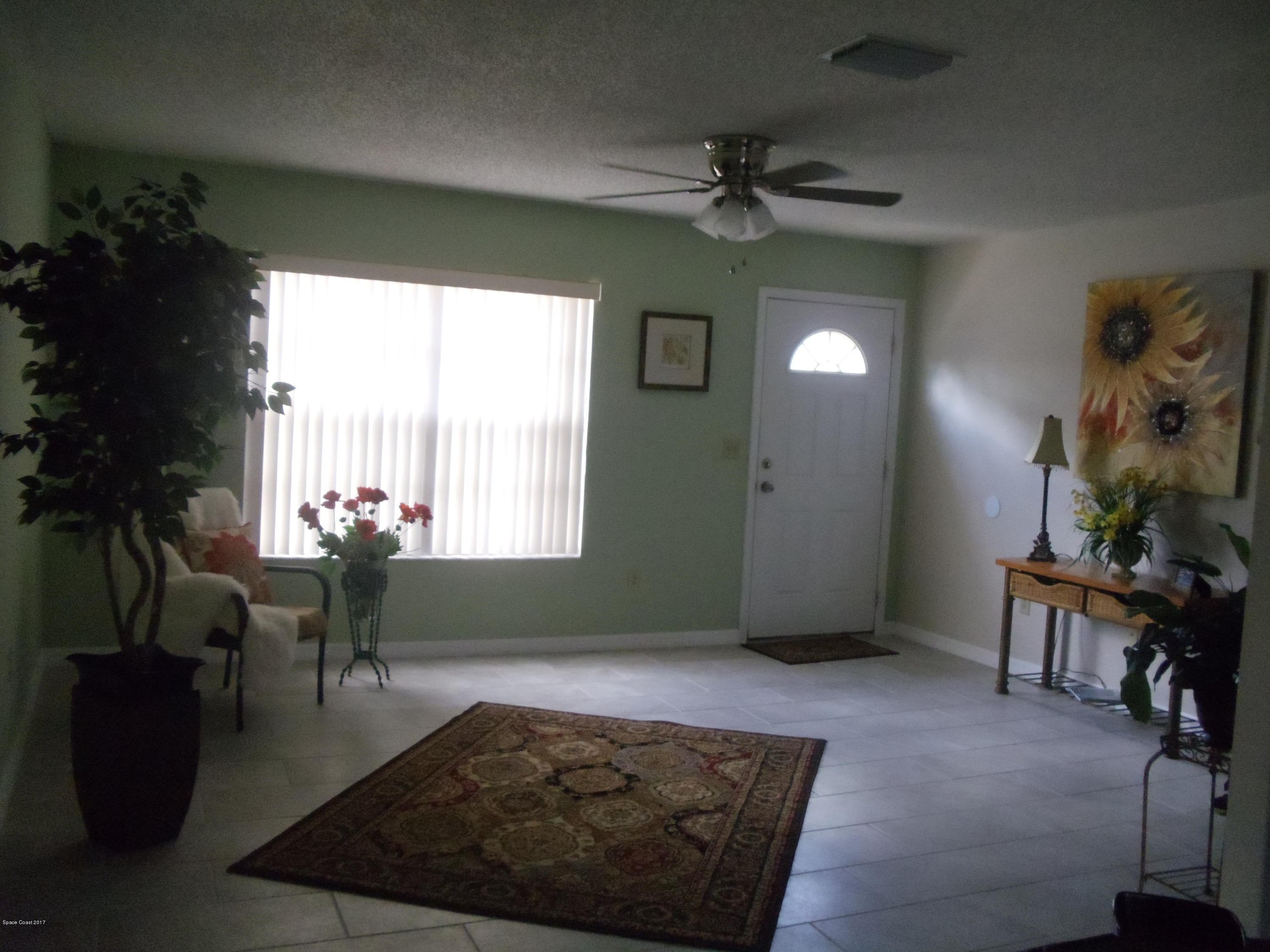 271 Trilby Road Southwest Palm Bay, FL 32908 - Photo 11 of 27 a living room with furniture and a large window