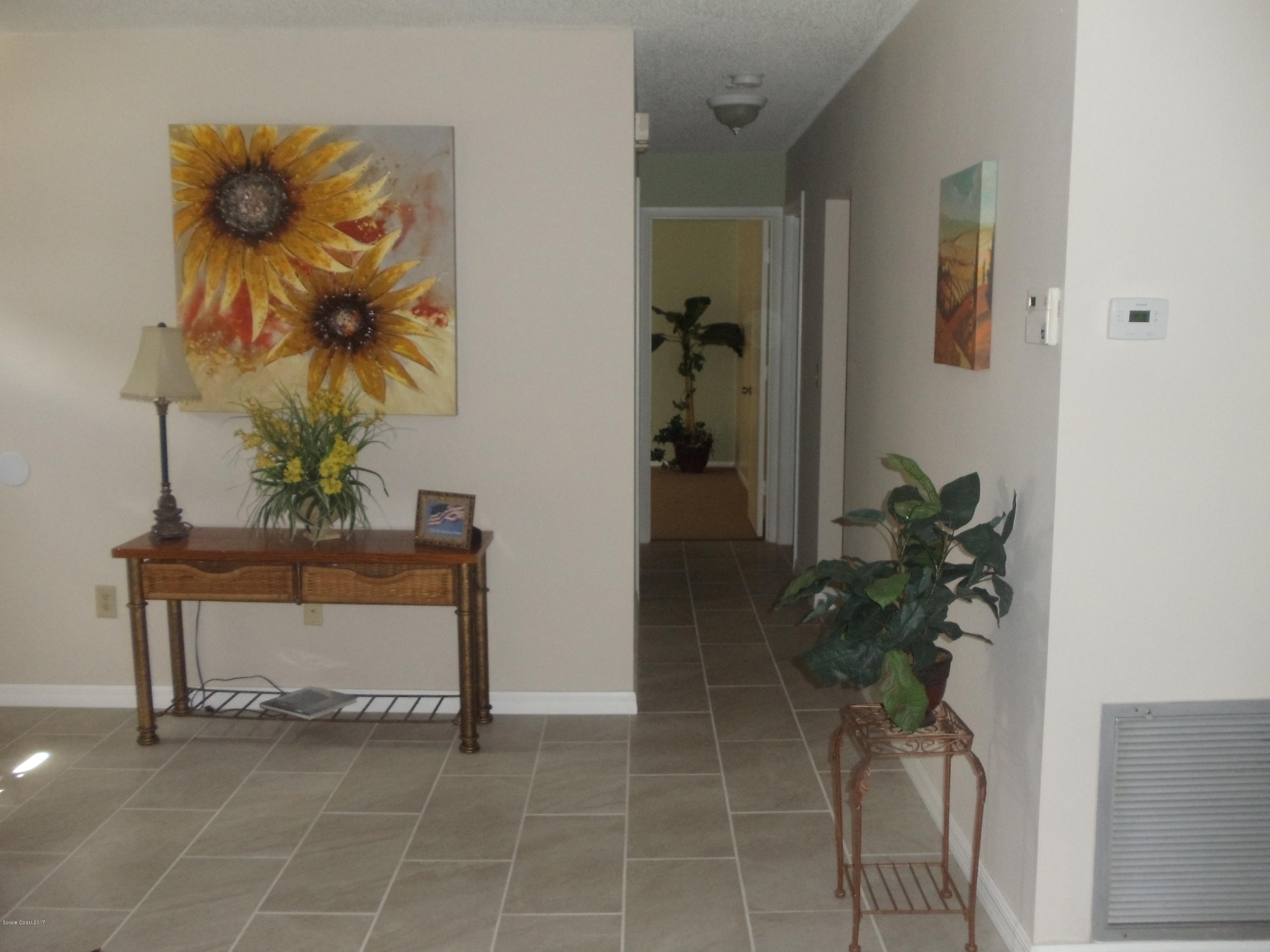 271 Trilby Road Southwest Palm Bay, FL 32908 - Photo 17 of 27 a vase of flowers sitting on a table in a room