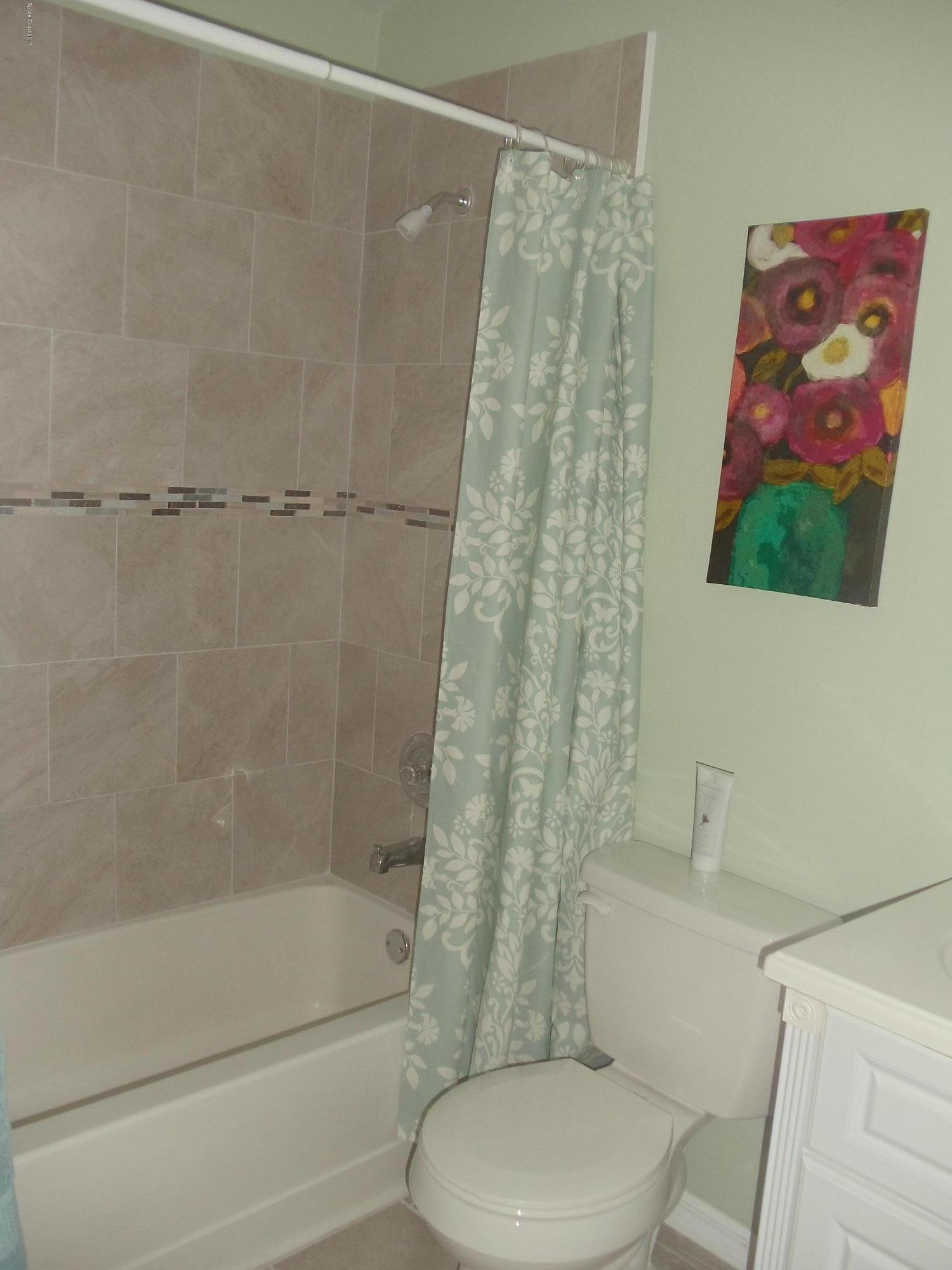 271 Trilby Road Southwest Palm Bay, FL 32908 - Photo 18 of 27 a bathroom with a toilet and a shower