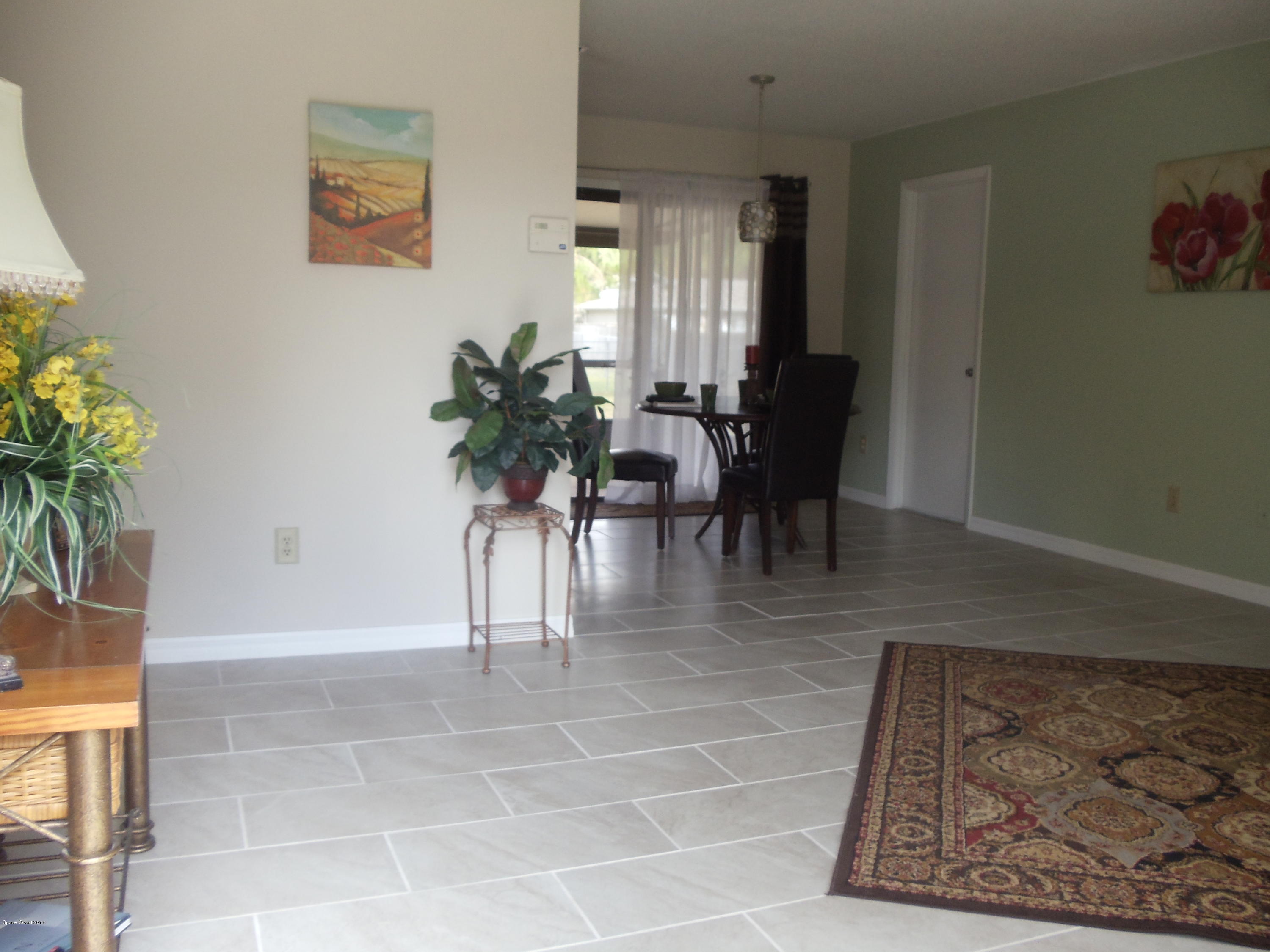 271 Trilby Road Southwest Palm Bay, FL 32908 - Photo 5 of 27 a view of dining room with furniture and a potted plant