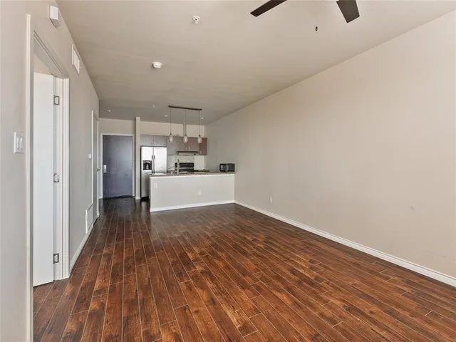 a view of a kitchen with wooden floor and a sink