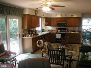 219 Media Line Road Broomall, PA 19008 - Photo 2 of 6 a kitchen with a table chairs microwave and cabinets