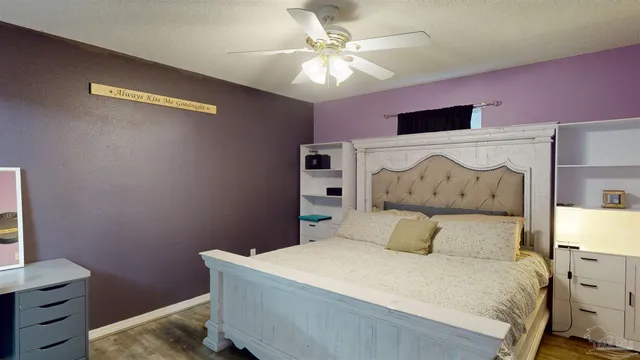 a bedroom with a large bed and a chandelier