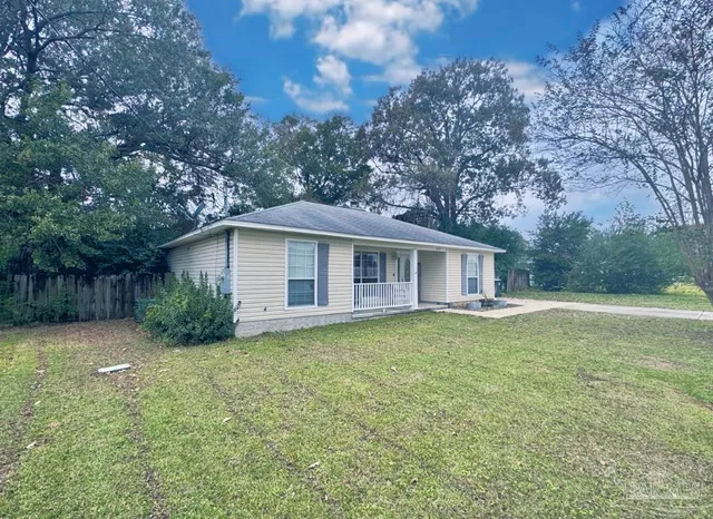 a view of a house with a backyard