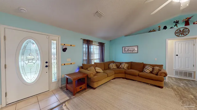 a spacious bedroom with a bed and a flat screen tv