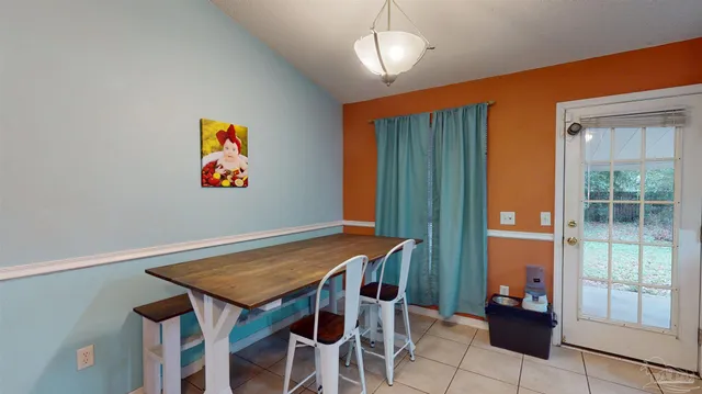 a living room with kitchen island furniture and a chandelier