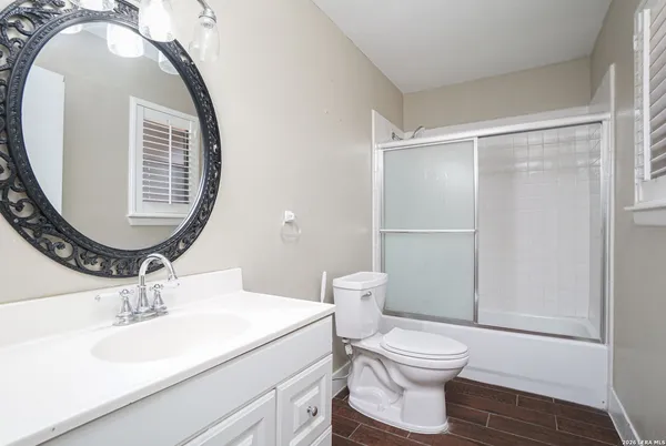 a bathroom with a sink a toilet and a mirror