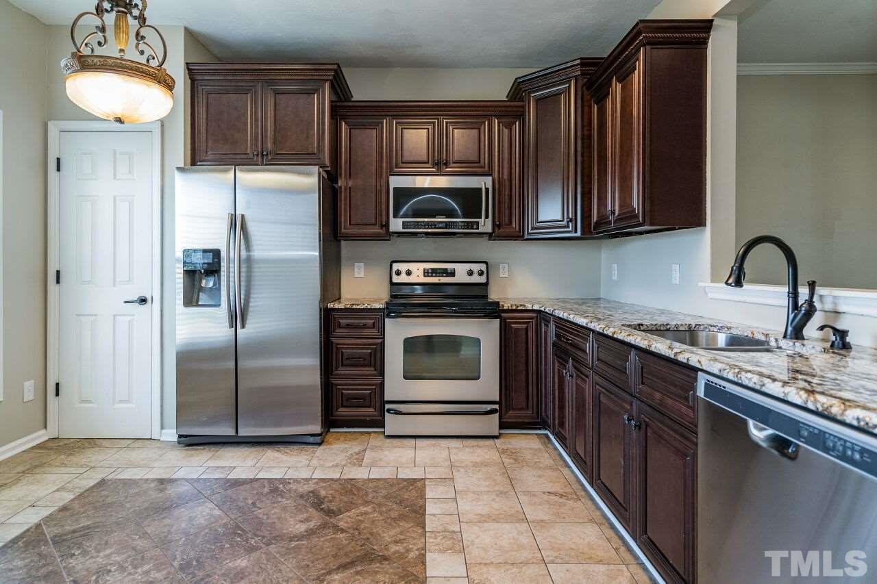 2905 Alder Ridge Lane Raleigh, NC 27603 - Photo 12 of 26 There is also a pantry for additional storage needs. Stainless appliances complete the package in this lovely space.