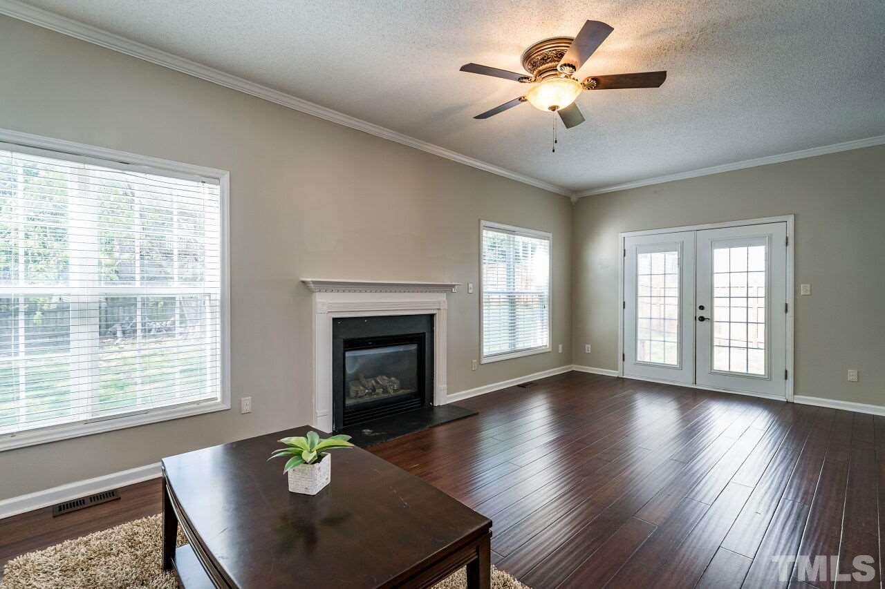 2905 Alder Ridge Lane Raleigh, NC 27603 - Photo 4 of 26 The fireplace is the focal point in this spacious room.