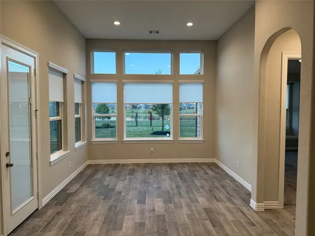 a bed sitting in a room next to a window