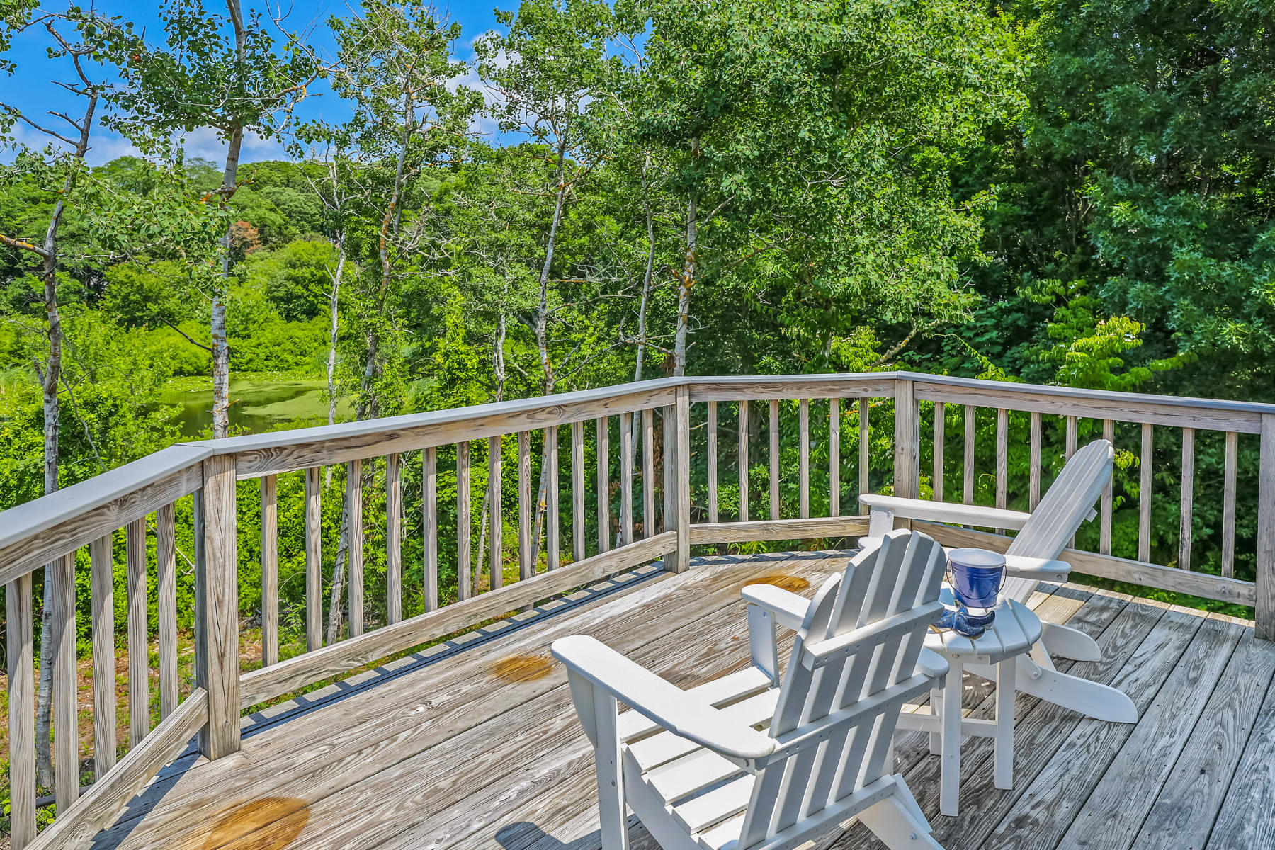 48 Beach Road Orleans, MA 02653 - Photo 38 of 45 a view of a chair and table on the wooden deck