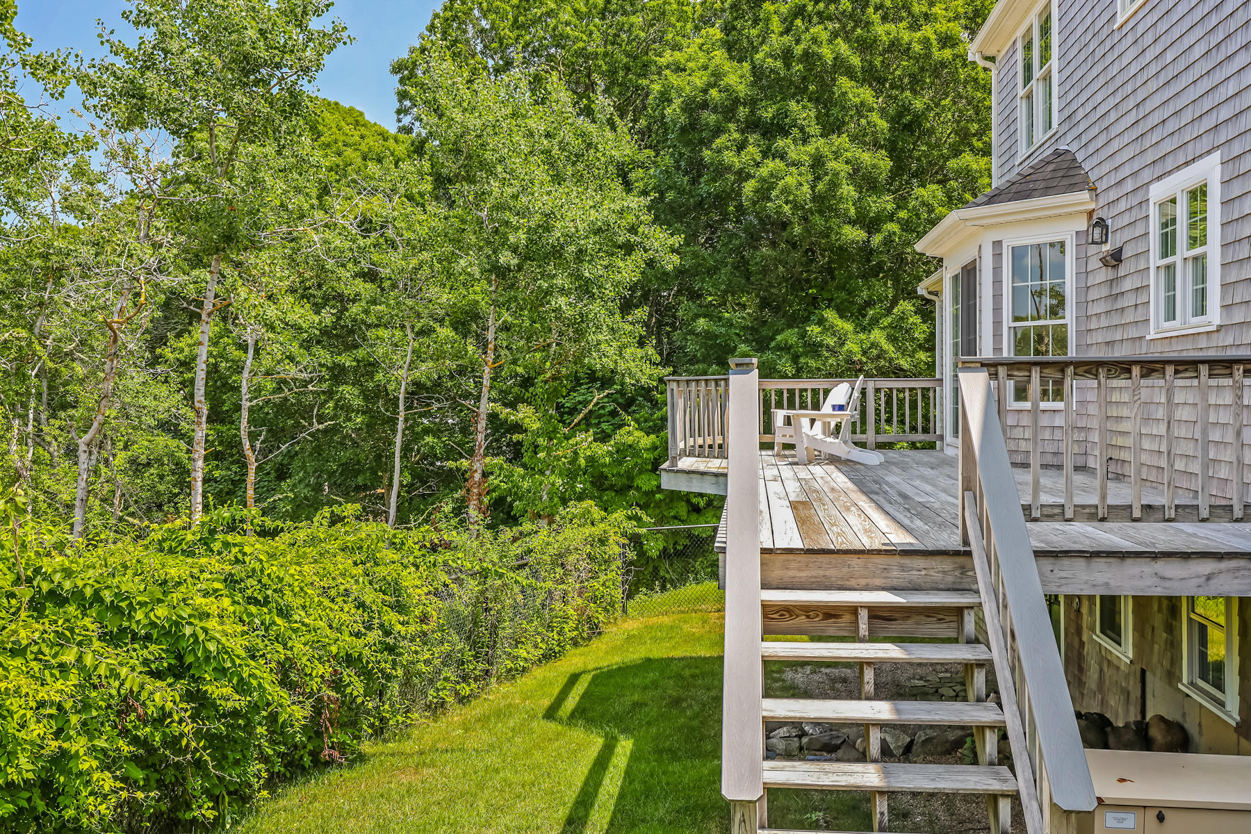 48 Beach Road Orleans, MA 02653 - Photo 40 of 45 a view of a large building with large tree and plants