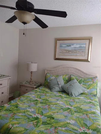 a bedroom with a bed and a painting on the wall