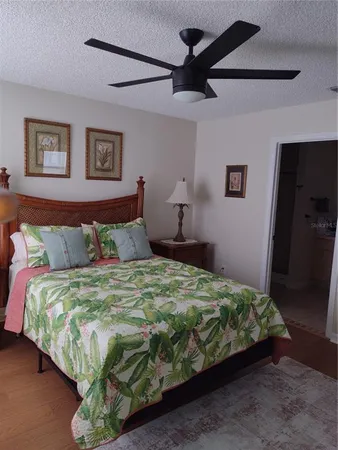 a bedroom with a bed and a painting on the wall