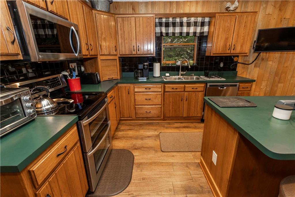 2488 County Line Road Champion, PA 15622 - Photo 12 of 50 a kitchen with a sink a stove and cabinets