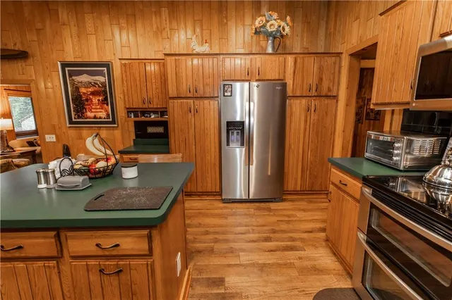 a kitchen with stainless steel appliances granite countertop a refrigerator and a stove