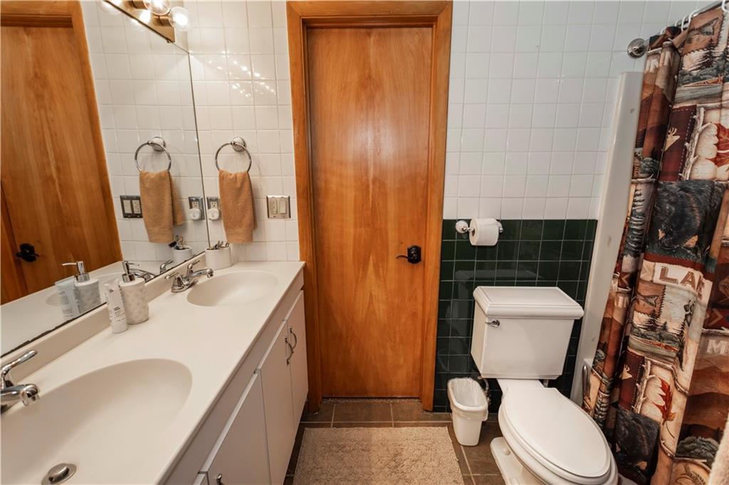2488 County Line Road Champion, PA 15622 - Photo 19 of 50 a bathroom with a sink a toilet a mirror and shower