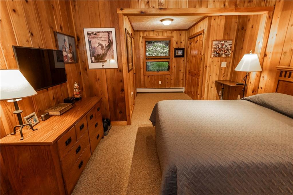 2488 County Line Road Champion, PA 15622 - Photo 20 of 50 a bedroom with a bed and a flat tv screen on dresser