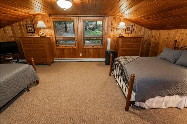 a bedroom with a bed and a flat tv screen