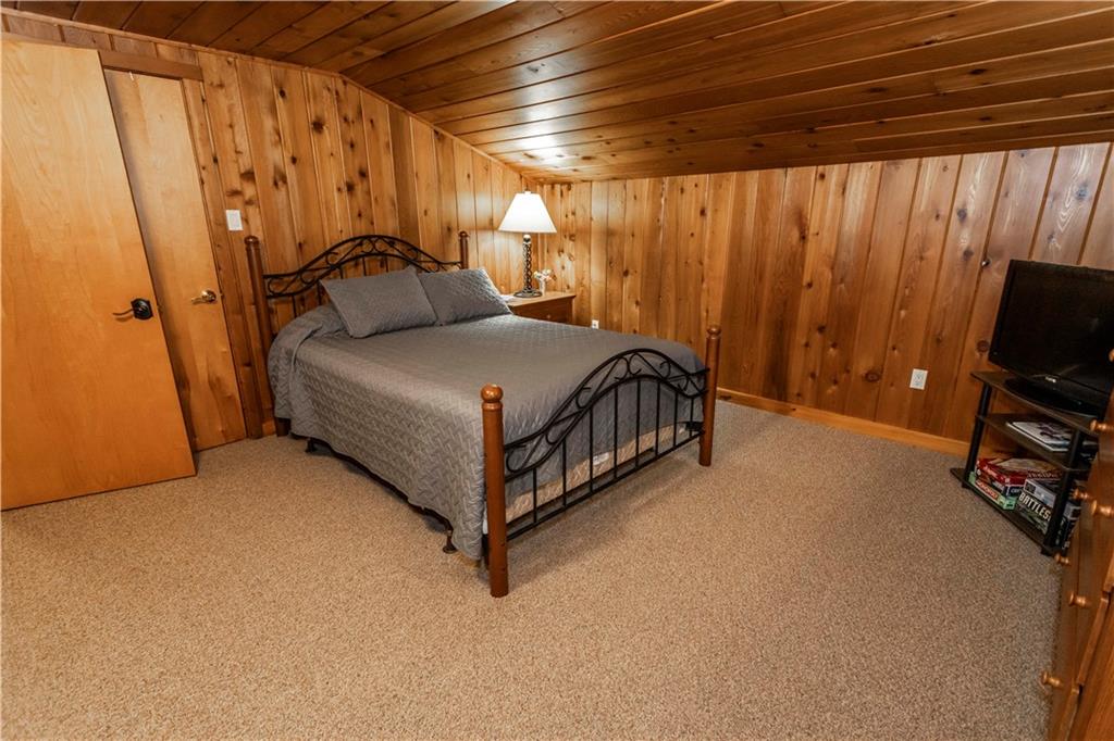2488 County Line Road Champion, PA 15622 - Photo 31 of 50 a bedroom with a bed and a flat tv screen