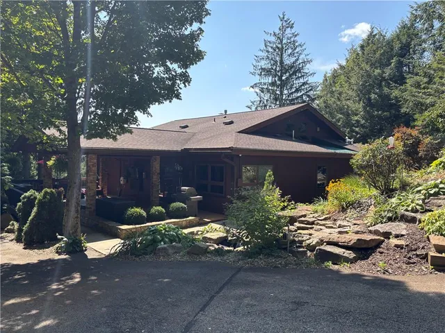 a view of a house with yard and sitting area