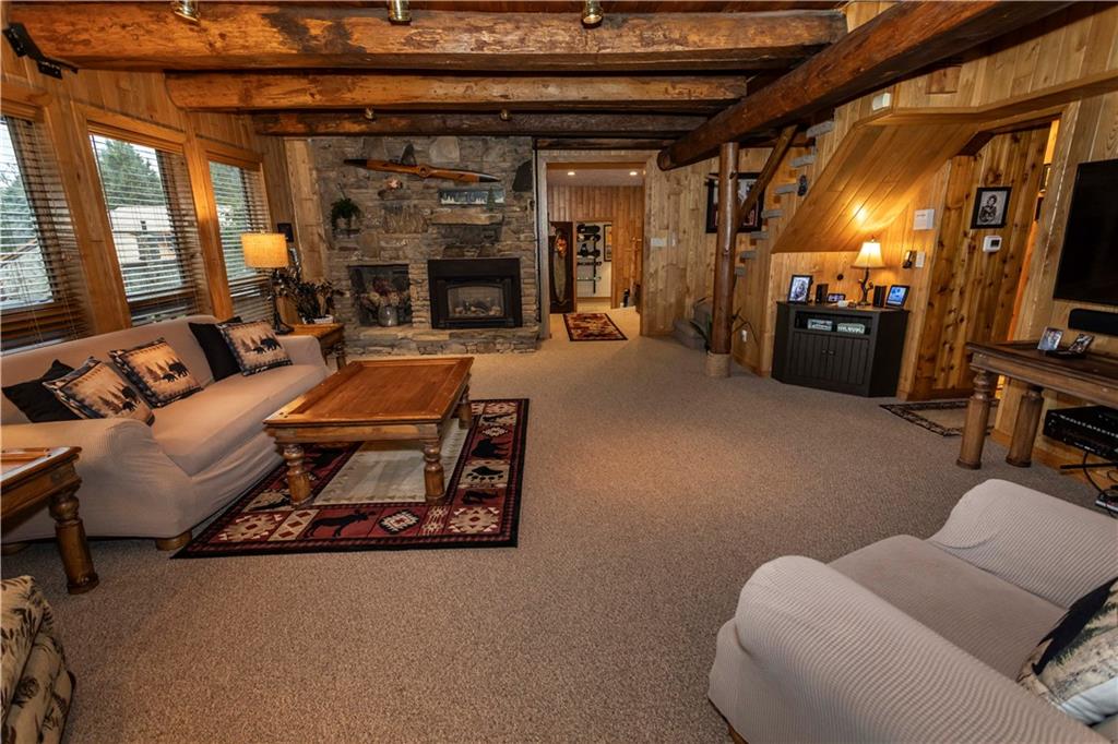 2488 County Line Road Champion, PA 15622 - Photo 8 of 50 a living room with furniture a fireplace and a flat screen tv
