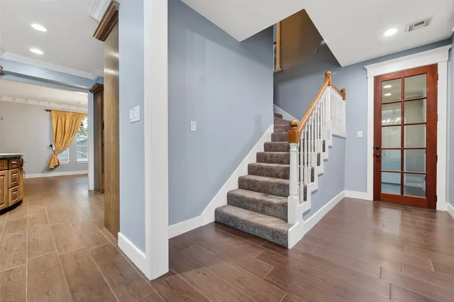 a view of entryway and hall with wooden floor
