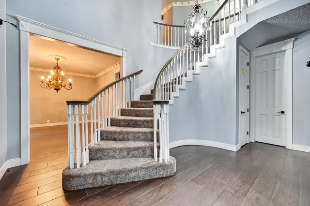 a view of entryway and hall with wooden floor