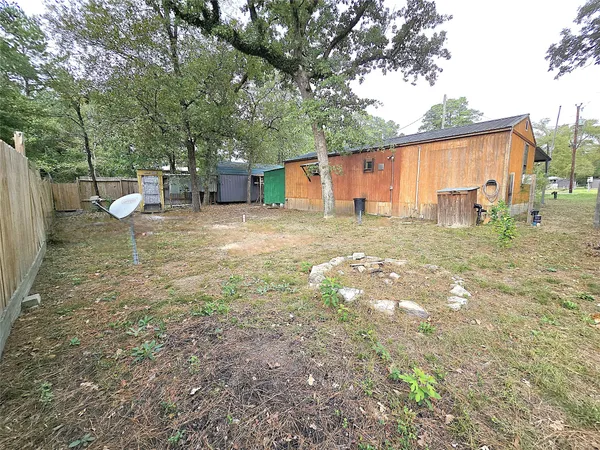 a backyard of a house with table and chairs
