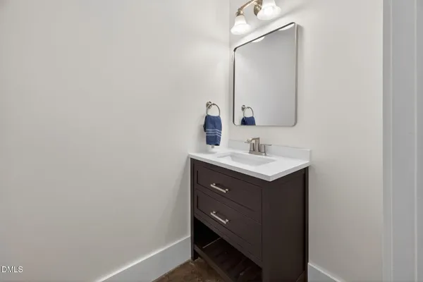a bathroom with a sink vanity and a mirror