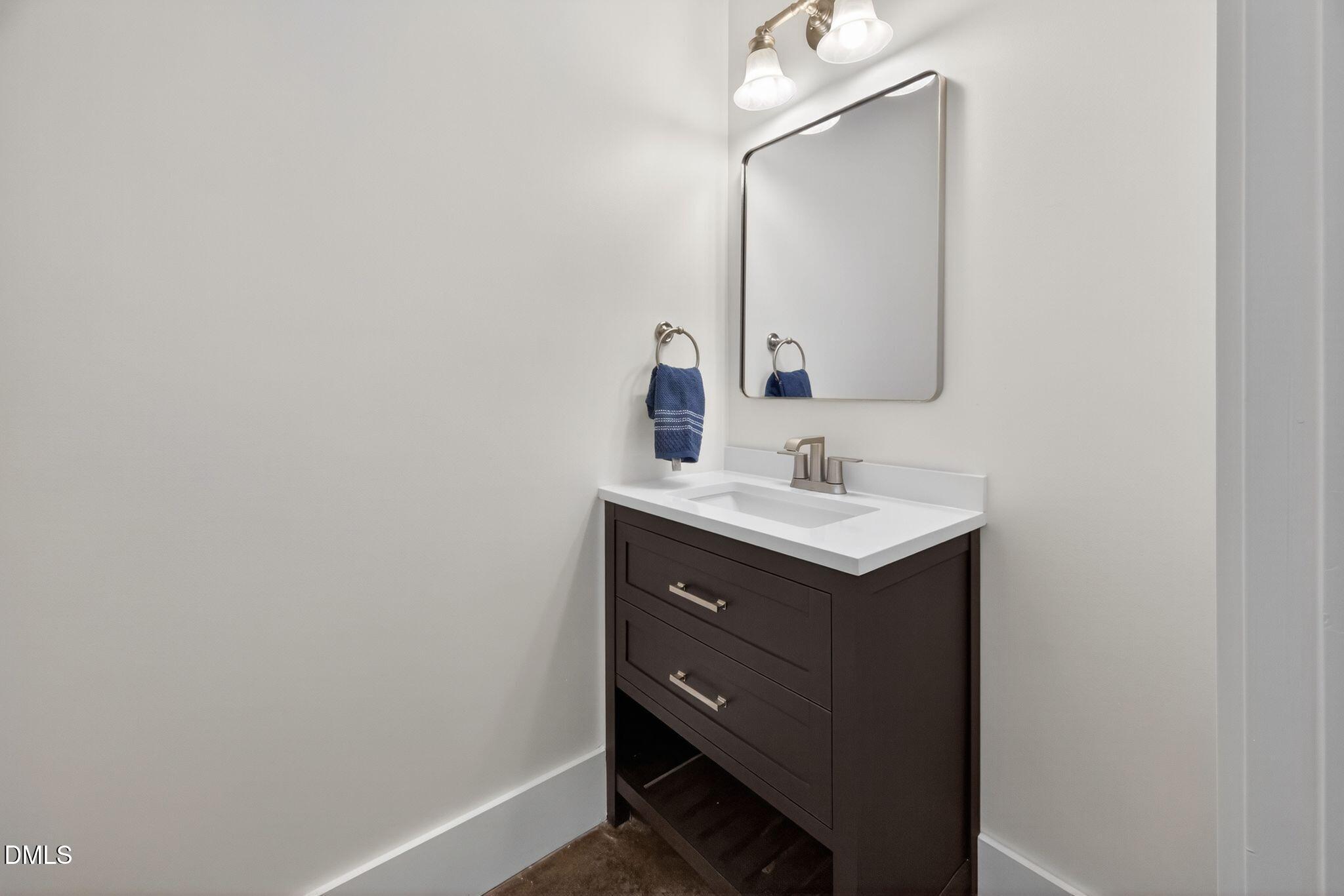 Undisclosed Address Raleigh, NC 27601 - Photo 12 of 25 a bathroom with a sink vanity and a mirror