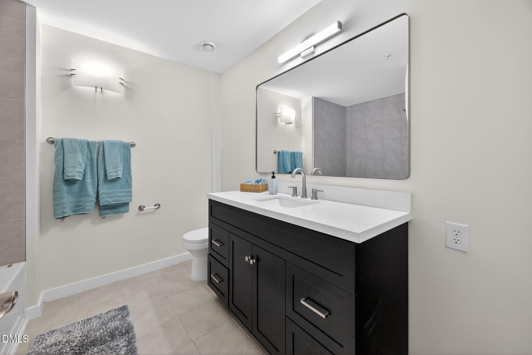 Undisclosed Address Raleigh, NC 27601 - Photo 14 of 25 a bathroom with a sink and a mirror