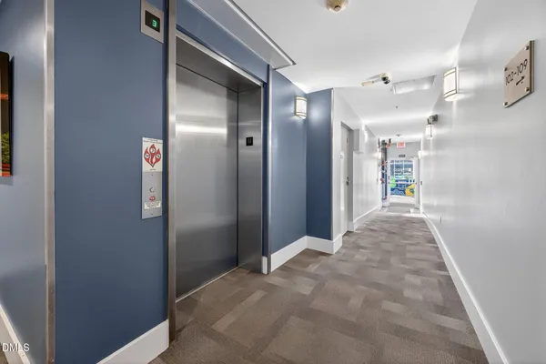 a view of a hallway with wooden shelves