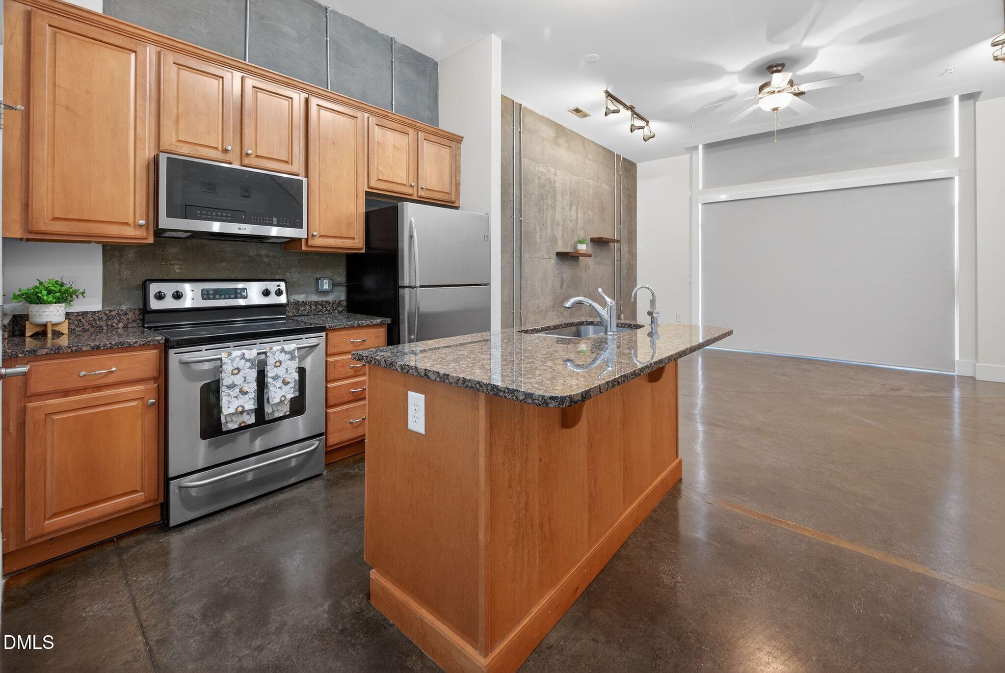 Undisclosed Address Raleigh, NC 27601 - Photo 5 of 25 a kitchen with stainless steel appliances granite countertop a stove a sink and a refrigerator