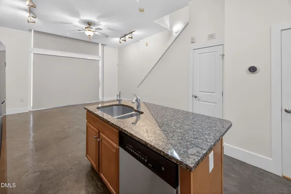 a kitchen with a sink a counter space and stainless steel appliances