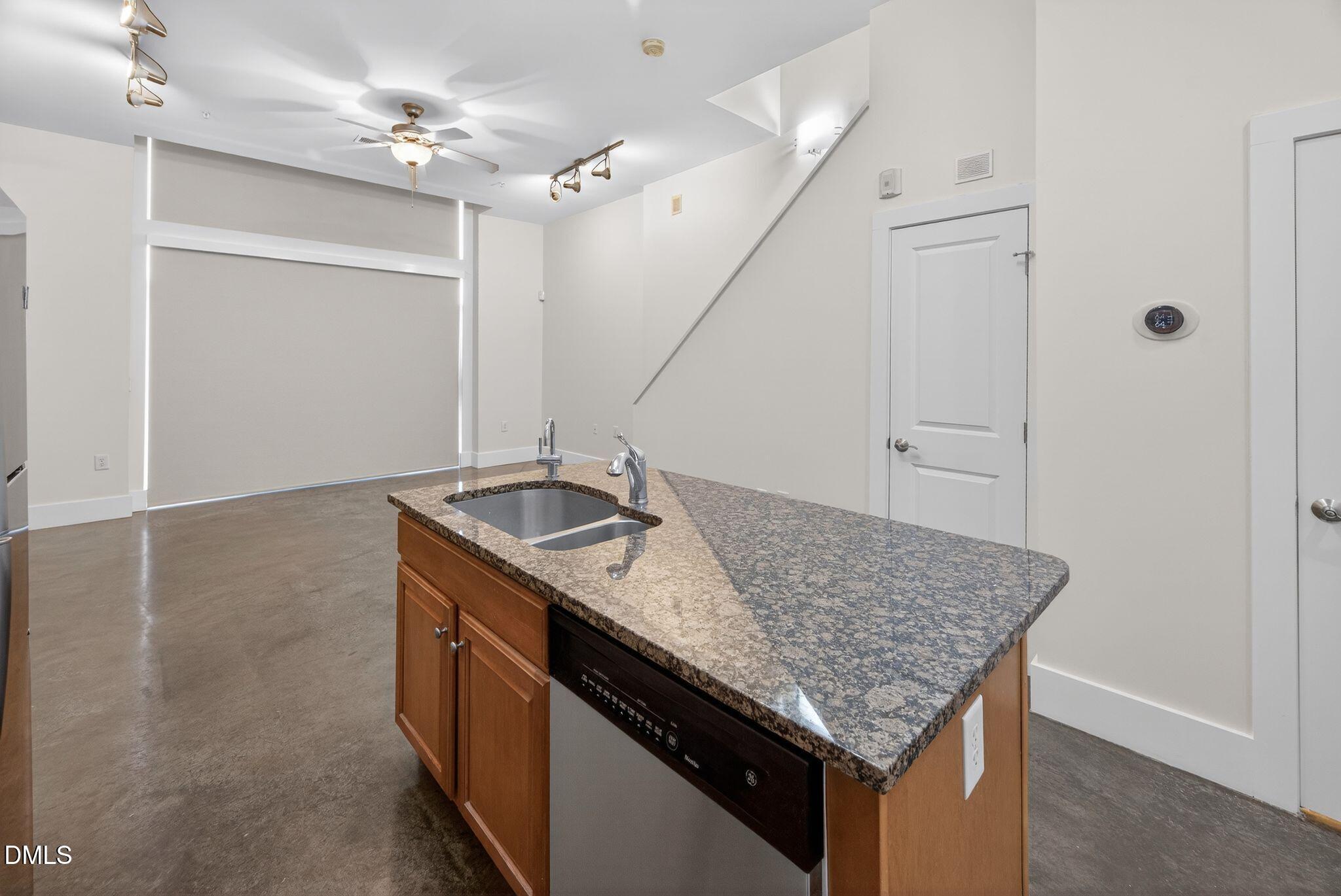 Undisclosed Address Raleigh, NC 27601 - Photo 6 of 25 a kitchen with a sink a counter space and stainless steel appliances