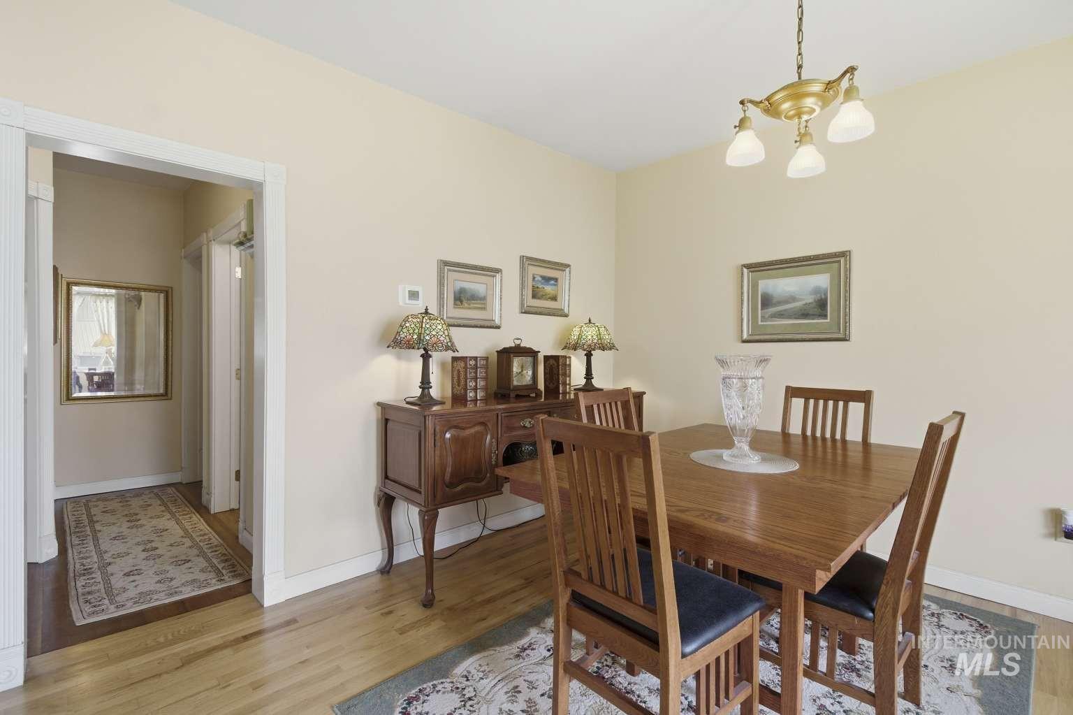 901 Main Street Kendrick, ID 83537 - Photo 13 of 50 Dining area featuring wood-finish flooring and a brass-tone chandelier
