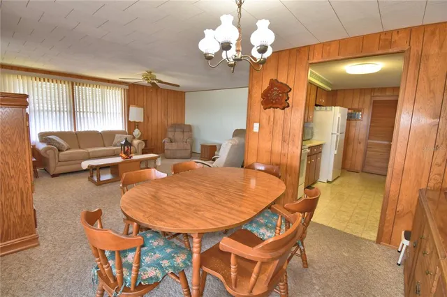 a dining room with furniture and chandelier