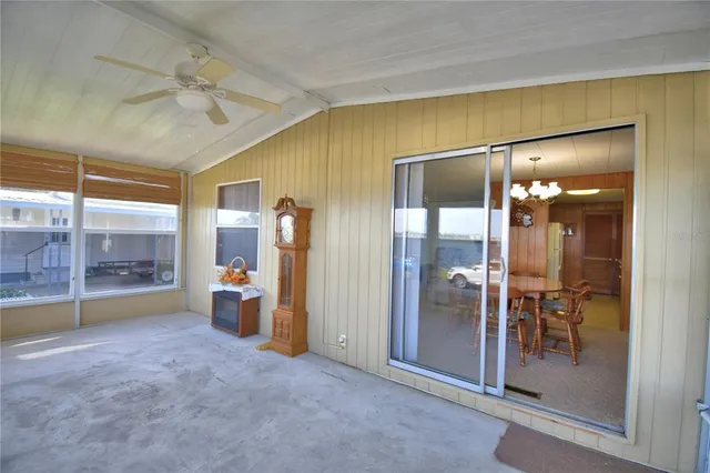a bedroom with a large bed and wooden floor