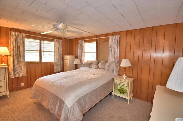 a bedroom with a large bed and a large window