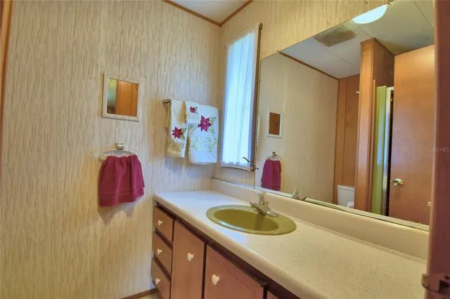 a bathroom with a shower and a sink