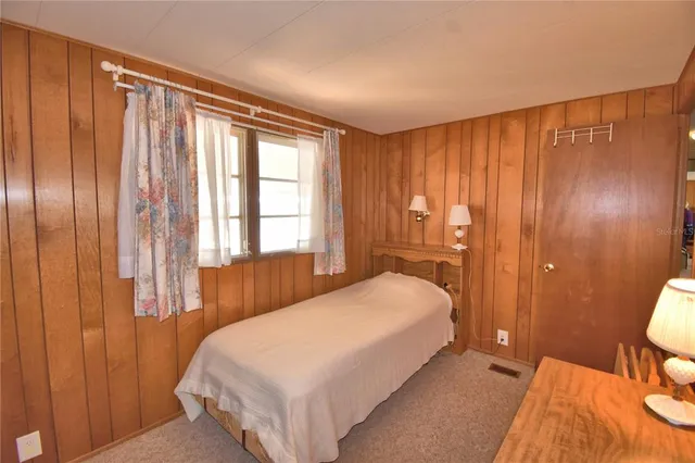 a bedroom with a bed and a mirror