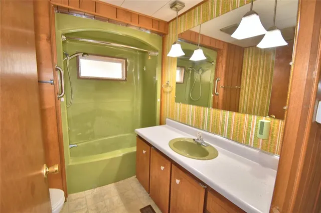 a bathroom with a sink a toilet and bathtub