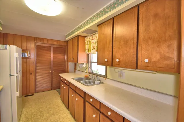 a bathroom with a double vanity sink and large mirror