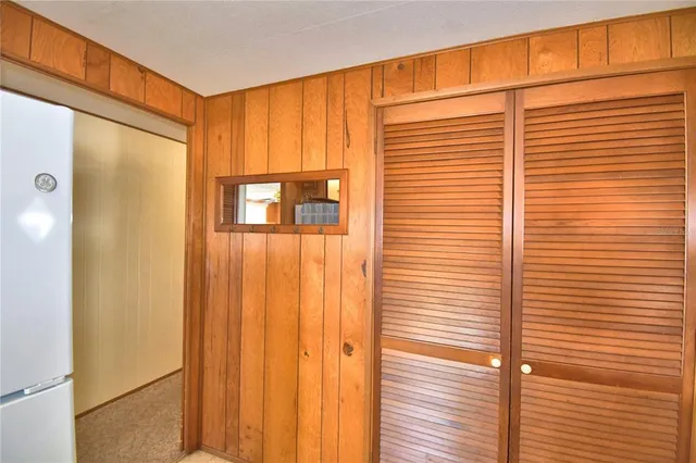 a living room with furniture a large window and a chandelier